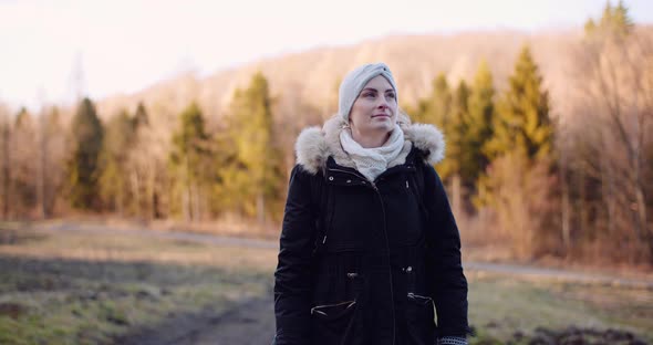 Smiling Woman with White Scarf Looking Into Camera