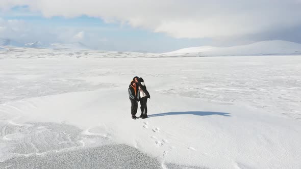 Happy Mother With Son Takes Selfie On Frozen Lake