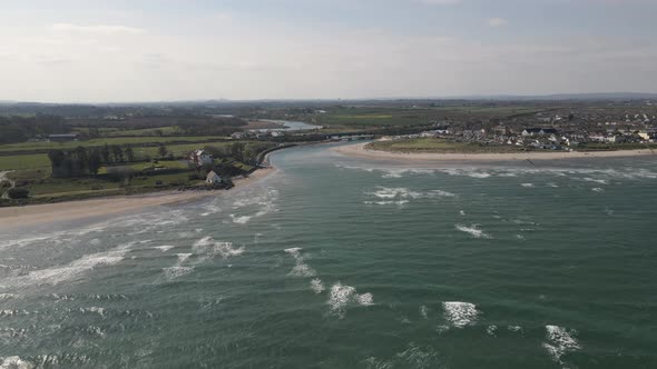 Drone shot of a small seaside town in Ireland on a sunny day.