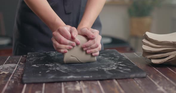 Professional Female Potter Preparing Kneading Clay for Work