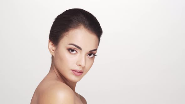 Studio portrait of young and beautiful brunette woman over