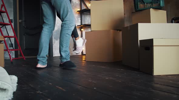 Waist Down of Couple in Slippers Relocating Into New Flat