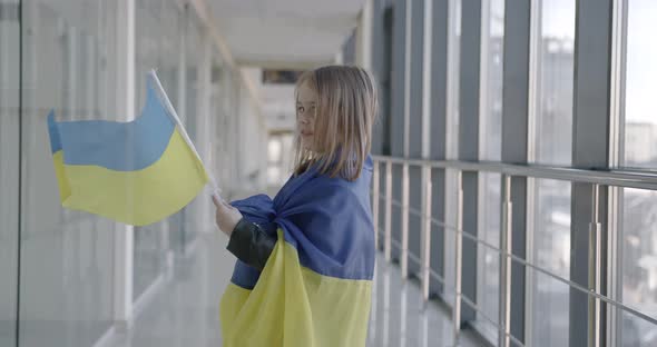 Child Wrapped in Ukrainian Flag Showing National Flag