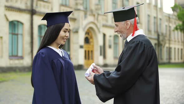 Presiding Officer Giving Diploma to Female Student, Shaking Hand, Convocation
