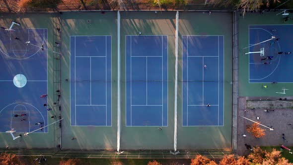 Static overhead view of a group of people playing tennis at Parque Araucano, Las Condes, Santiago, C