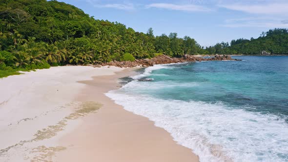 Aerial  Drone Footage of Tropical Beach and White Ocean Waves at Mahe Island Seychelles