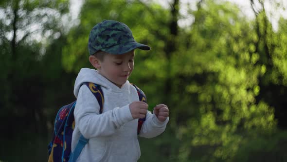 Closeup of a Boy Walking with a Backpack in a Beautiful Natural Landscape