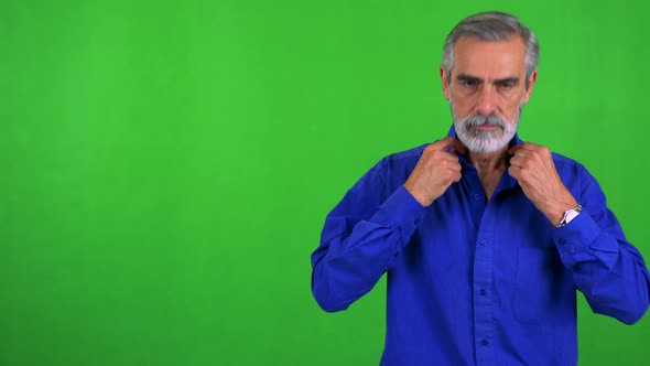 Old Senior Man Adjusts Clothes and Smiles To Camera - Green Screen - Studio