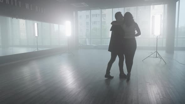 Handsome Man Dancing with His Girlfriend in a Dance Studio