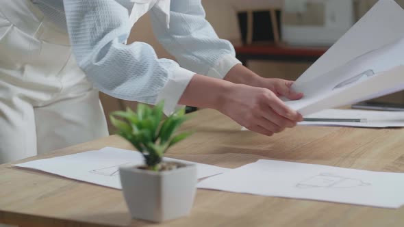 Close Up Of Asian Woman Designer Is Arranging The Layout Bond On The Table At The Office