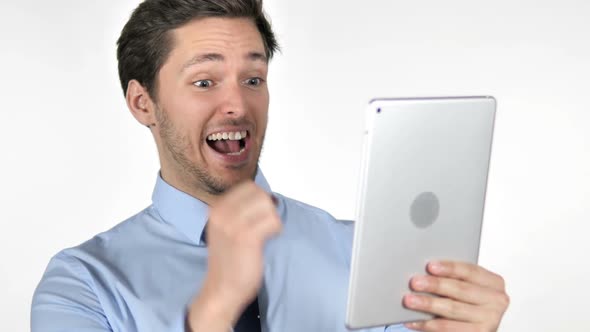 Young Businessman Celebrating Success While Using Tablet on White Background