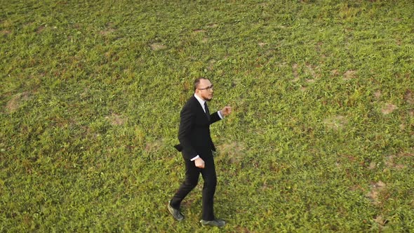 Businessman Dance at Grass Mountain Hill Aerial