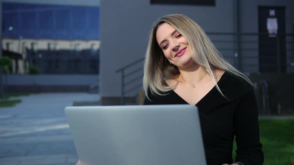 Young Business Woman with Laptop Outside the Street