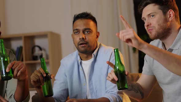 Male Friends Drinking Beer and Watching Tv at Home