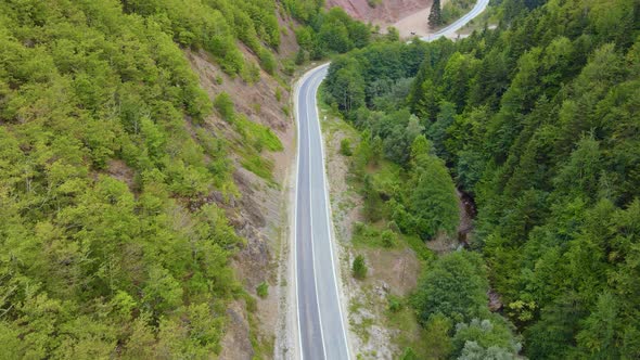 steep green mountains, deep forest and mountain road, beautiful valley  