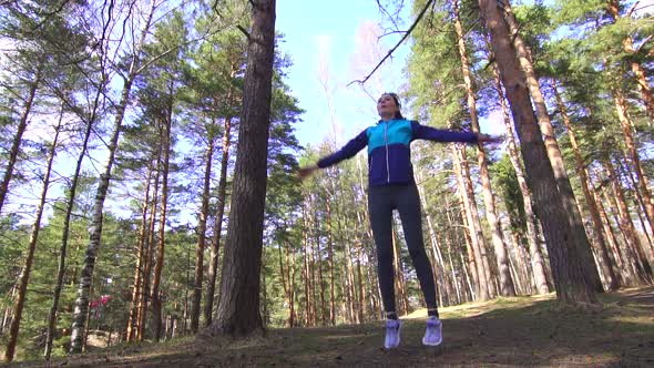 Sports Girl Warmup in a Sunny Forest