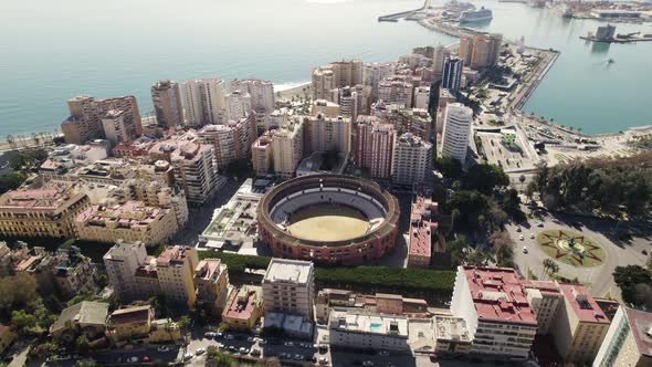 La Malagueta bullring and surrounds close to port, Malaga; descending drone