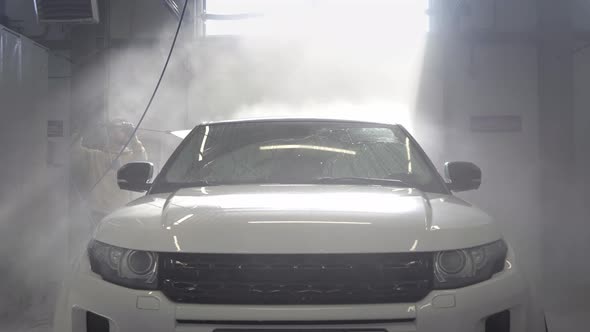 Car Washing at Selfservice Station Hose for Spraying Water in a Garage