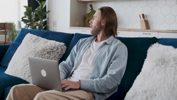 Casually Dressed Male Entepreneur is Looking Sad Angry and Frustrated Closing His Laptop