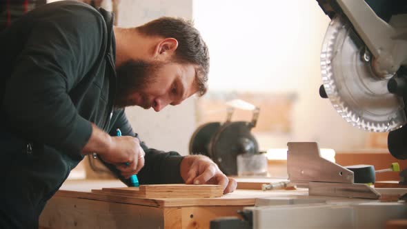 Carpentry Working - Bearded Man Making Marks on the Plywood