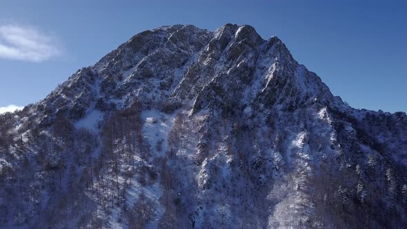 Epic panoramic aerial view of jagged Montseny mountain range and pulling back to reveal road on side