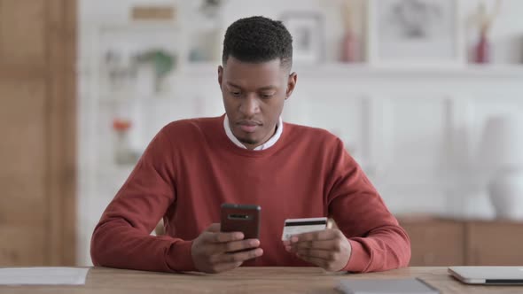 African Man Unsuccessful Online Payment on Smartphone