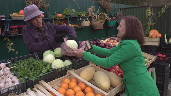 Buying Cabbage at the Market. 2 Shots.