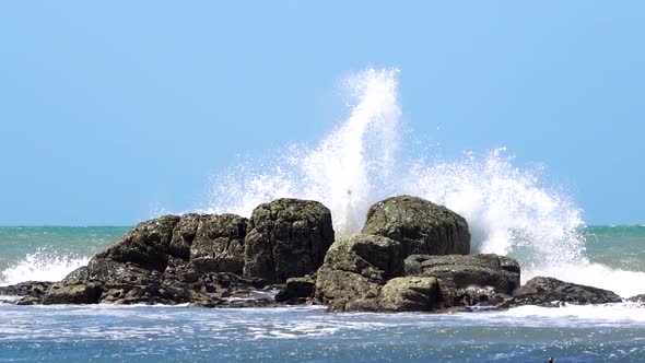 Waves crashing against rocks, Patagonia, Argentina, slow motion wide shot