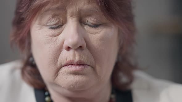 Closeup Face of Frustrated Depressed Senior Caucasian Woman Thinking Looking Around