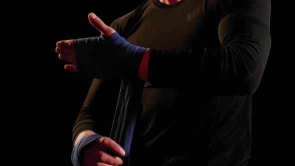 Mma Fighter Man Wrapping His Hands in Boxing Tape Before a Fight Close Up View