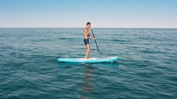 Man Surfing On Sup Board