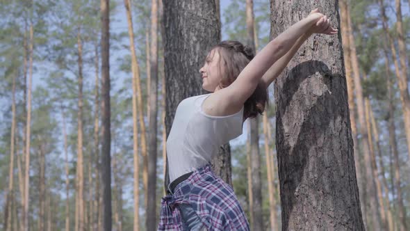 Pretty Young Woman Stretching Her Body, Doing Exercises in the Pine Forest. Healthy Lifestyle, Unity