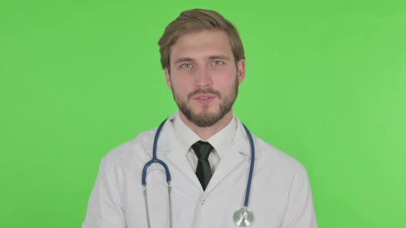 Young Doctor Talking on Online Video Call on Green Background