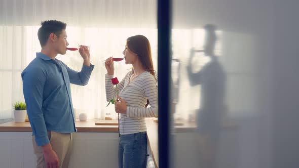 Asian young couple clinking glass of wine and drink on valentine's day.