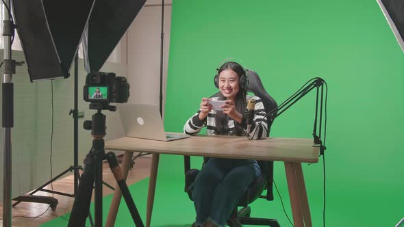 Camera Recording Woman Gamer Looking At Camera While Playing Mobile Phone Game On Green Screen