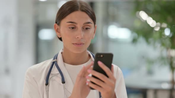 Portrait of Female Doctor Using Smartphone 