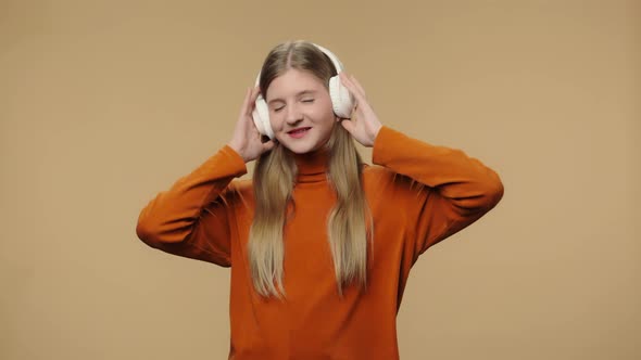 Portrait of Fashion Model Enjoying Music in Big Wireless White Headphones