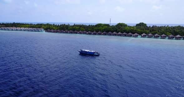 Beautiful fly over travel shot of a sunshine white sandy paradise beach and turquoise sea background