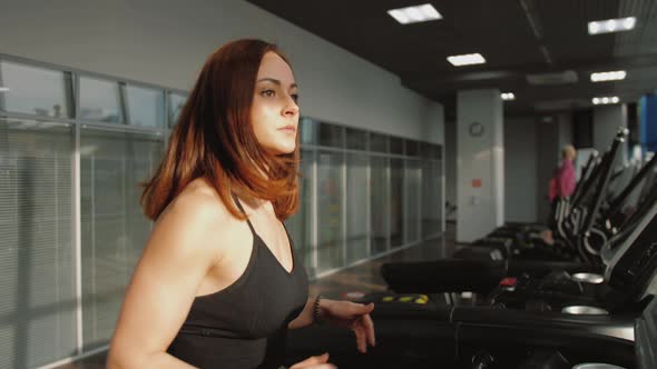Close Up Fitness Woman Running on Treadmill in Gym Having Cardio Training