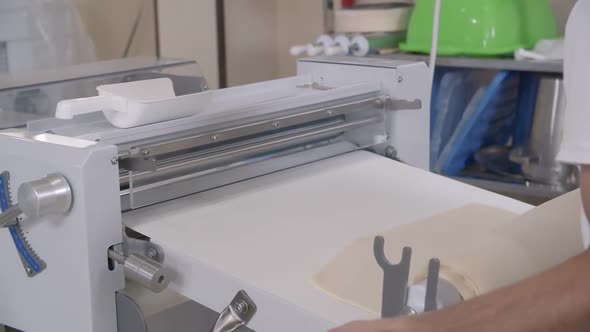 Closeup of Piece of Dough on the Bakery Dough Rolling Machine