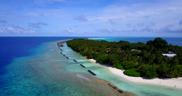 Tropical flying copy space shot of a paradise sunny white sand beach and turquoise sea background in