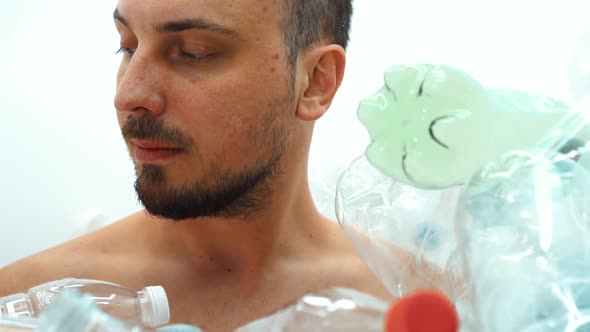 Man Sitting in a Pile of Plastic