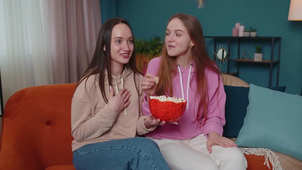 Girls Friends Siblings Watching Favorite Tv Show Movie and Eating Popcorn Sitting on Sofa at Home