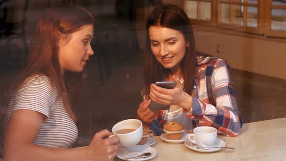 Beautiful women interacting with each other while having coffee