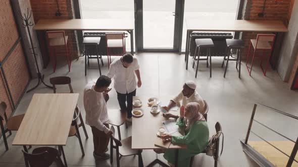 Diverse Colleagues Meeting in Coffee Shop