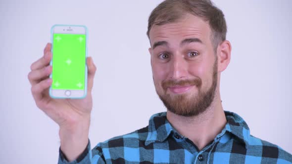 Face of Happy Bearded Hipster Man Showing Phone