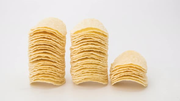 Stop motion animation stack potato chips on white background.