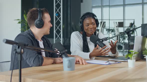 Confident African American Woman With White Man Hosting on Radio Show