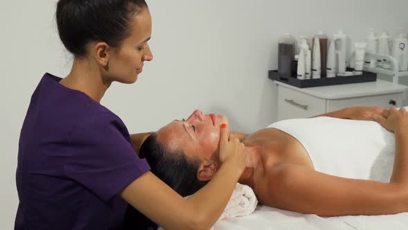 Therapist Performing Facial Massage for Mature Woman