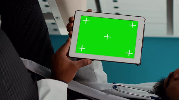 Vertical Video Male Medic Working with Greenscreen on Tablet at Examination